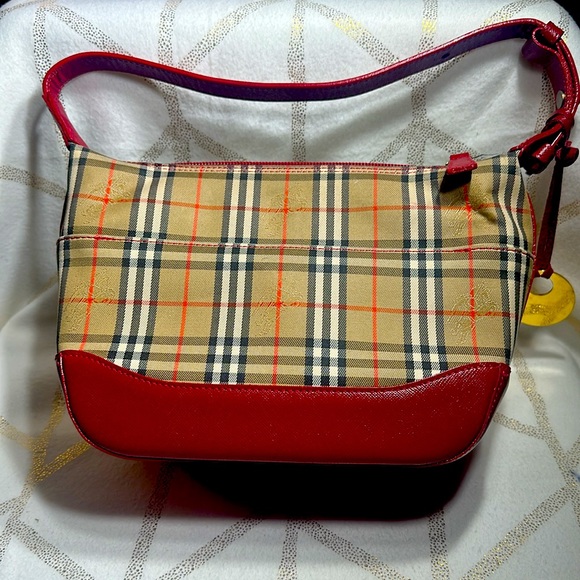 Small Burberry handbag with gold Burberry charm on the side. - Picture 2 of 4